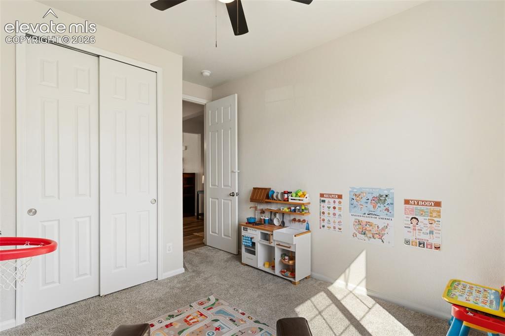 Image 26 of 33: Neutral-toned interior room featuring light gray carpet, white walls, and a