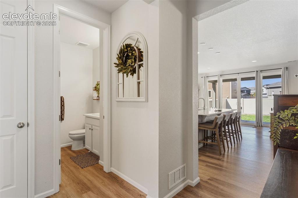 Image 8 of 33: Bright interior featuring wood-finish flooring and white painted walls