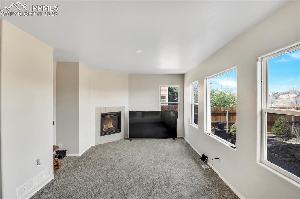 Image 14 of 25: Spare room featuring baseboards and carpet flooring