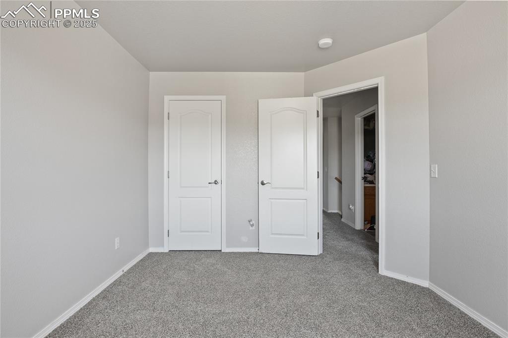 Image 28 of 45: Unfurnished bedroom featuring baseboards and carpet flooring