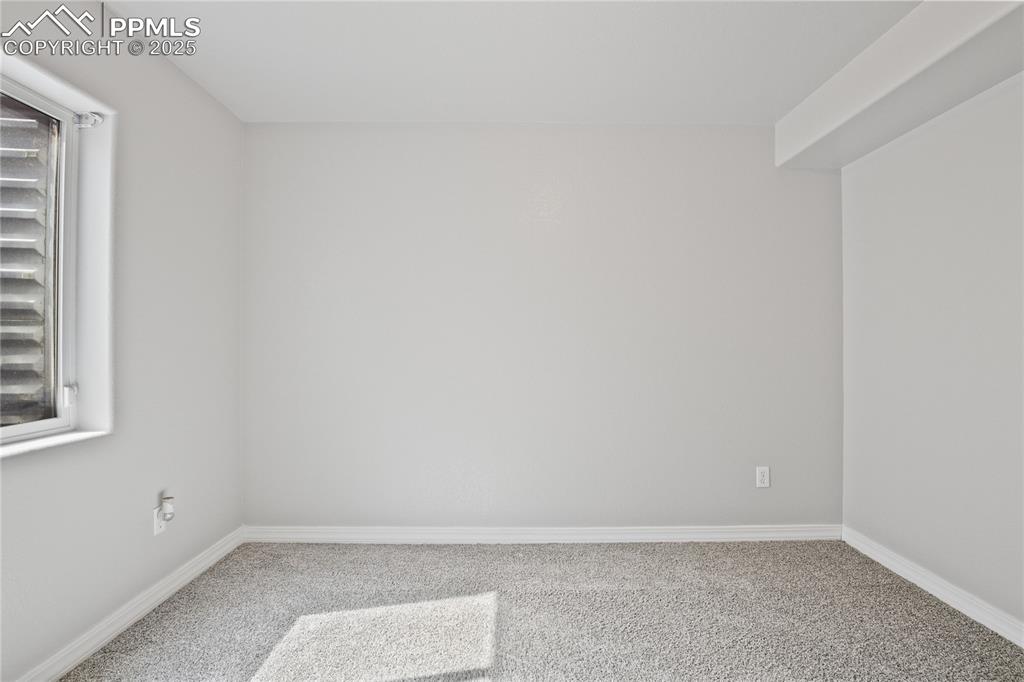 Image 32 of 45: Carpeted empty room featuring baseboards