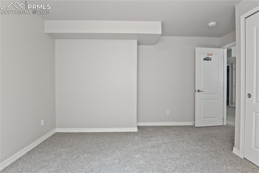 Image 33 of 45: Carpeted empty room with baseboards