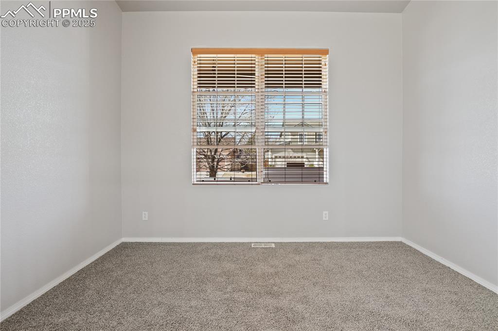 Image 4 of 25: Unfurnished room with baseboards and carpet flooring