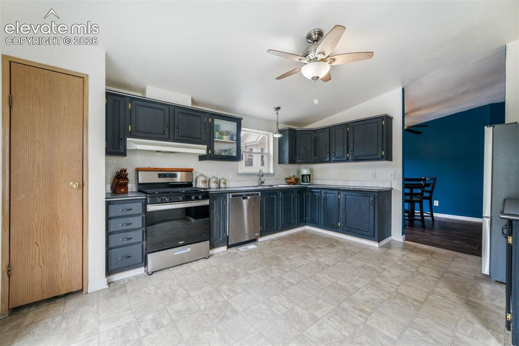 Image 15 of 50: Kitchen with a double basin sink with a gooseneck faucet