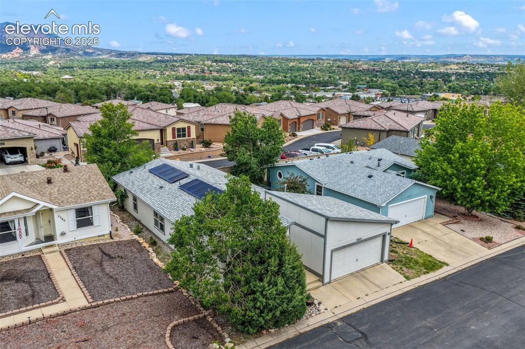 Image 47 of 50: Residential neighborhood with a mountain backdrop, featuring diverse archit