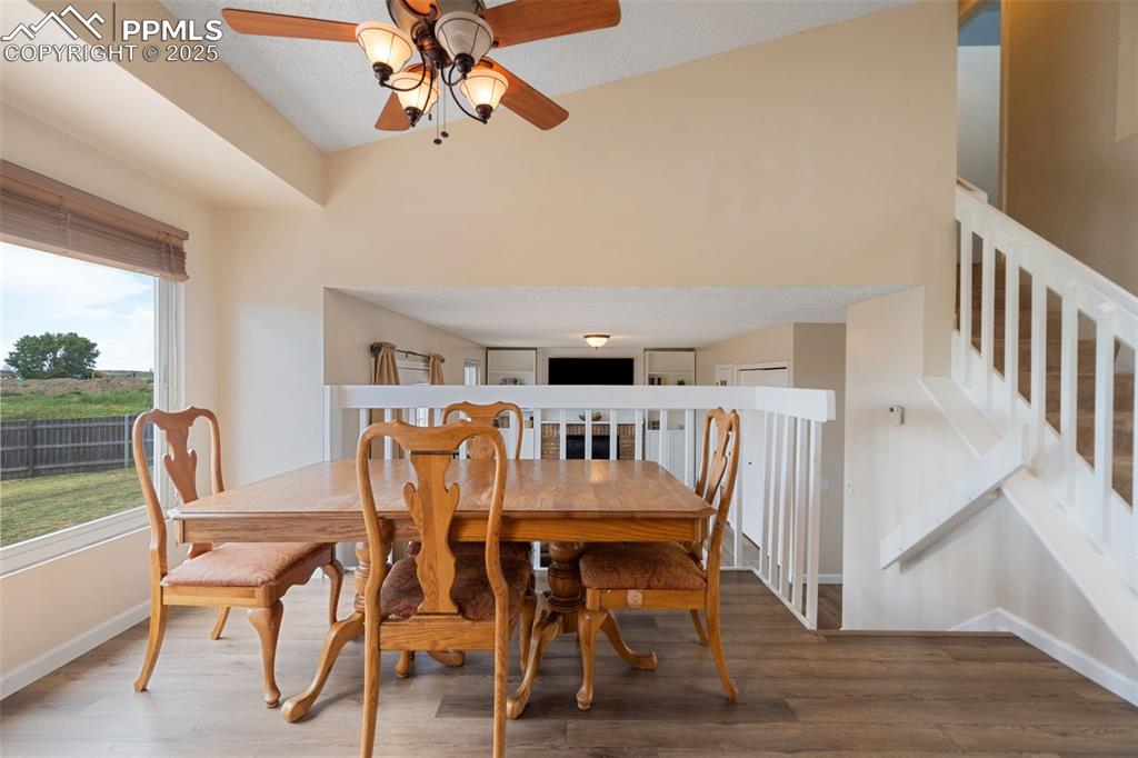 Image 15 of 33: Dining area featuring plenty of natural light, a ceiling fan, and wood fini