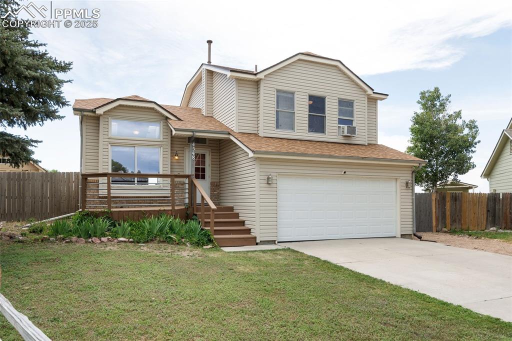 Image 3 of 33: View of front facade with an attached garage, driveway, and a shingled roof