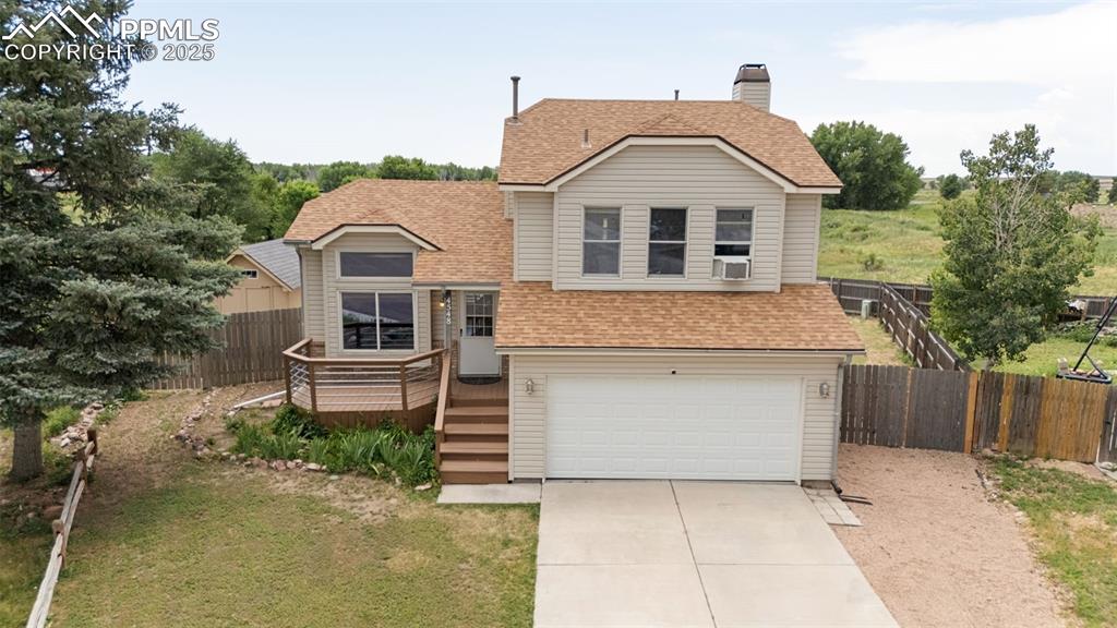 Image 4 of 33: View of front facade featuring roof with shingles, a garage, concrete drive
