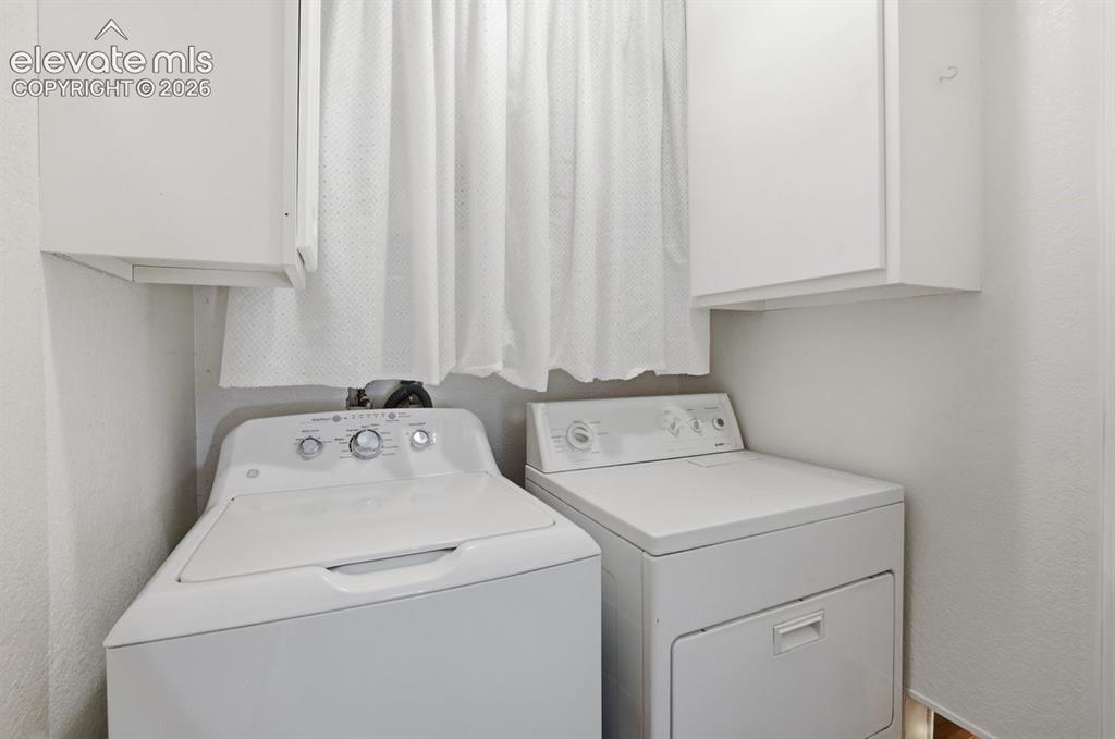 Image 12 of 45: Dedicated laundry room with a white washer and dryer included