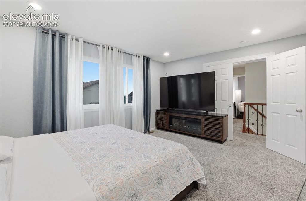 Image 20 of 45: Another view of the expansive primary suite highlighting recessed lighting 