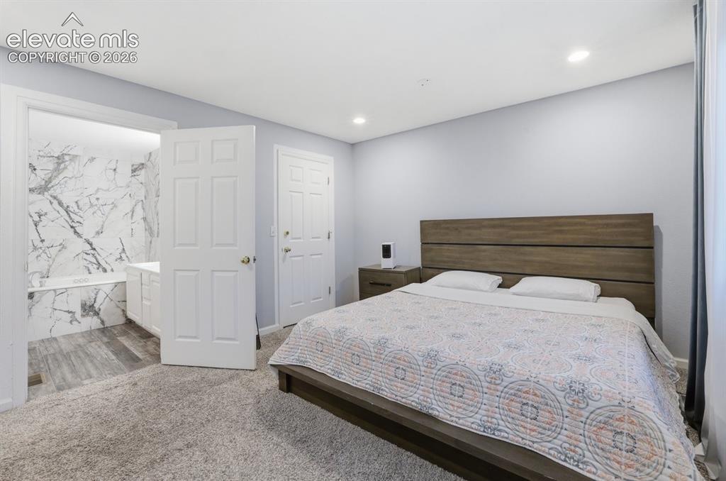 Image 21 of 45: Retreat-like primary suite with a seamless flow into the spa-inspired ensui