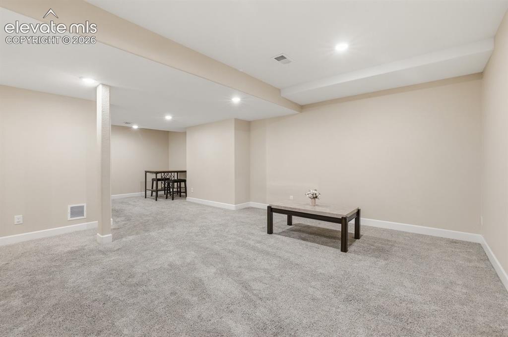 Image 30 of 45: Bright lower-level living space showcasing approximately 10-foot ceilings a