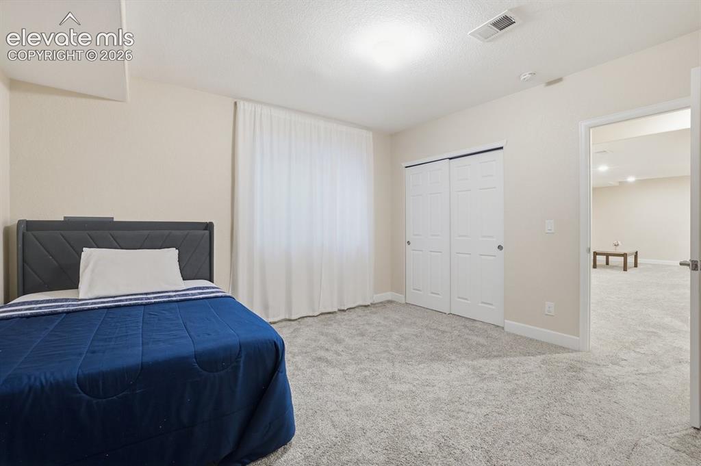 Image 32 of 45: Another look at the inviting lower-level bedroom featuring neutral finishes