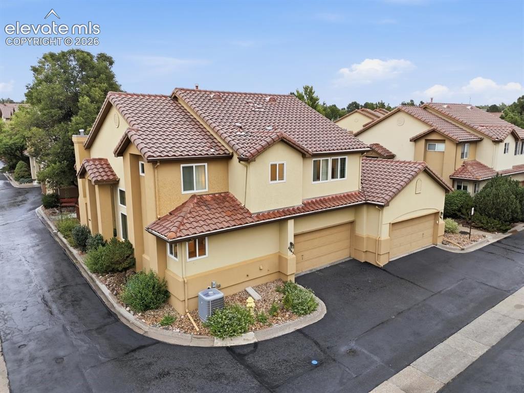 Image 39 of 45: Attractive duplex townhome featuring a stucco exterior, attached garage, an