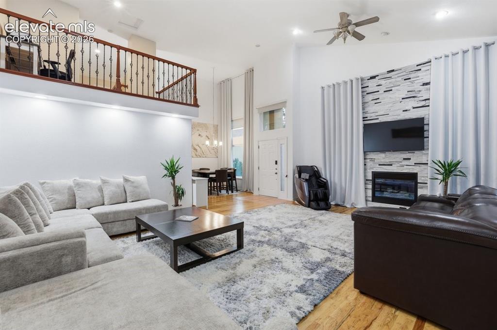 Image 4 of 45: Expansive living area featuring vaulted ceilings, wood-finish flooring, rec