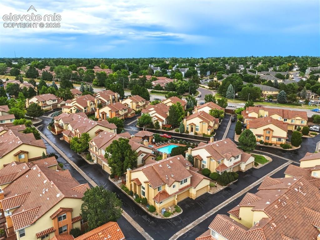 Image 41 of 45: Aerial view showcasing the well-maintained townhome community with mature l