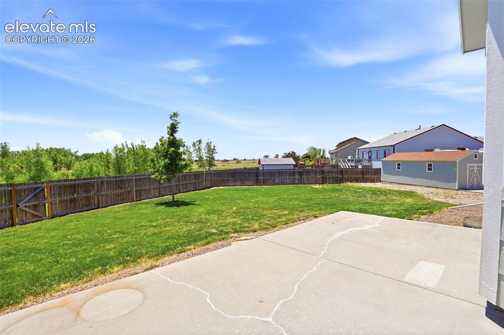 Image 29 of 41: Lovely well kept fenced yard backing to open space