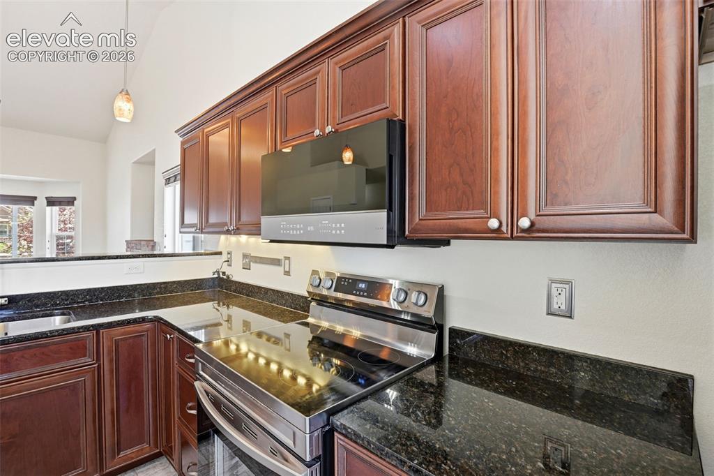 Image 9 of 41: Brand new stove in kitchen