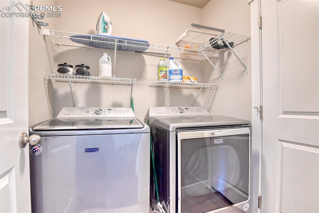 Image 16 of 45: Washroom featuring washer and clothes dryer