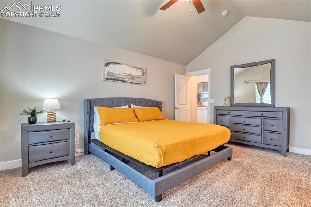 Image 17 of 45: Bedroom with light carpet, lofted ceiling, and a ceiling fan