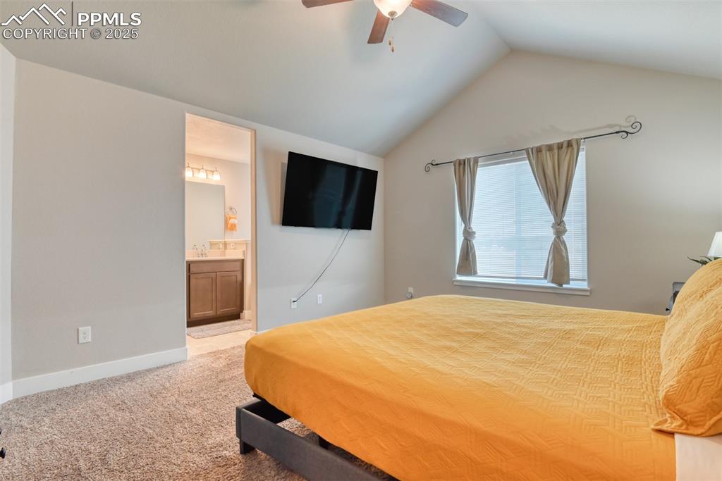 Image 18 of 45: Bedroom with light colored carpet, lofted ceiling, ceiling fan, and connect