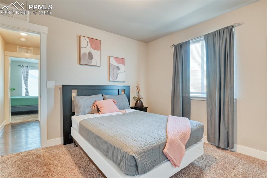 Image 25 of 45: Bedroom featuring light carpet