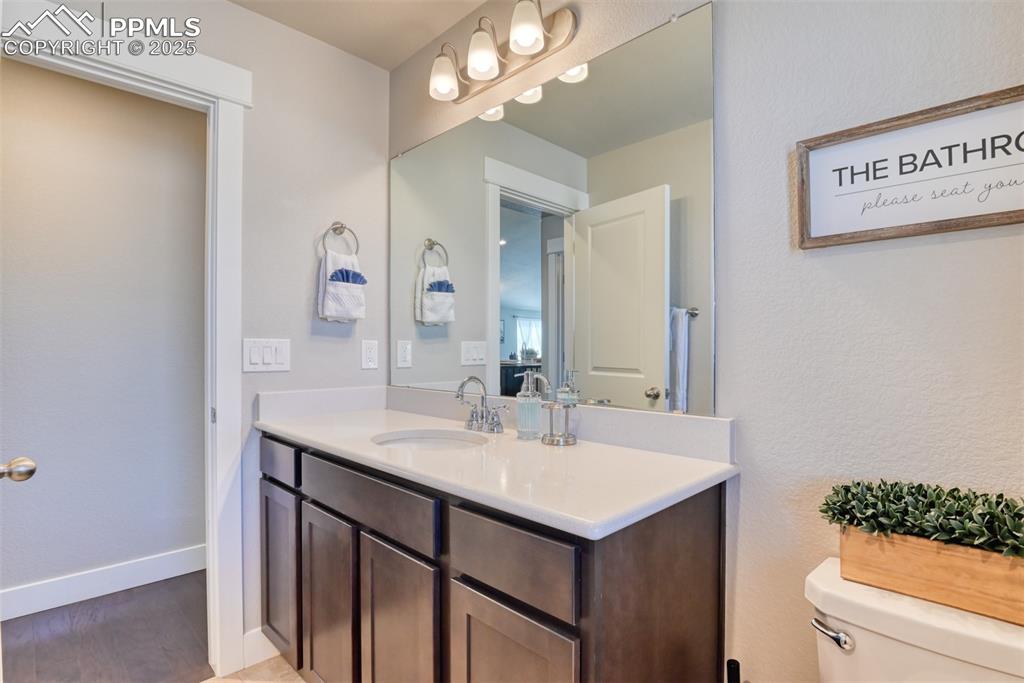Image 31 of 45: Bathroom featuring vanity and a textured wall