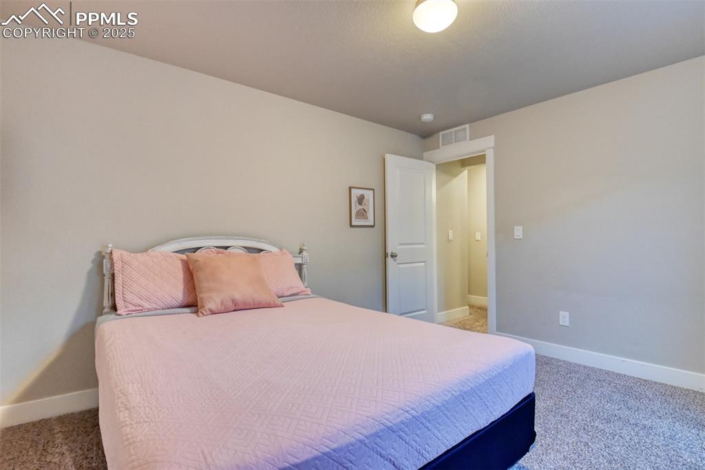 Image 33 of 45: Bedroom with light carpet and baseboards
