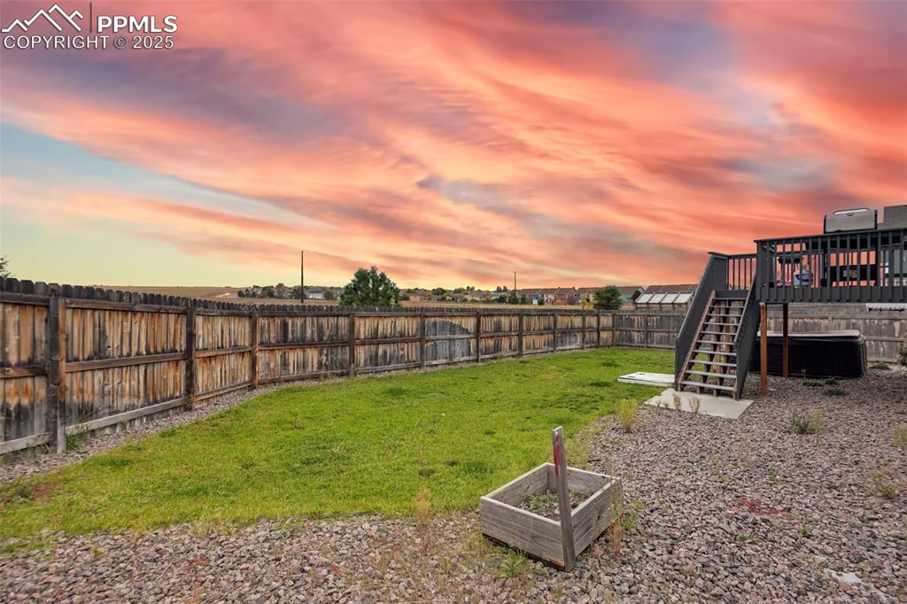 Image 39 of 45: Fenced backyard featuring stairs
