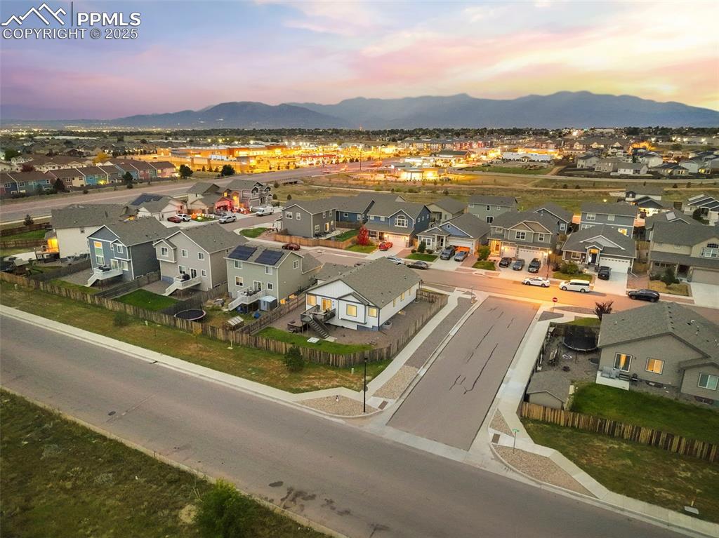 Image 40 of 45: Aerial view of residential area with a mountain backdrop