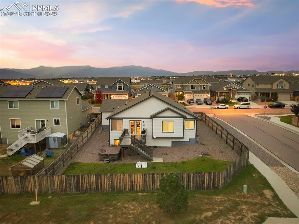 Image 45 of 45: View of front of home featuring a residential view, a fenced backyard, and