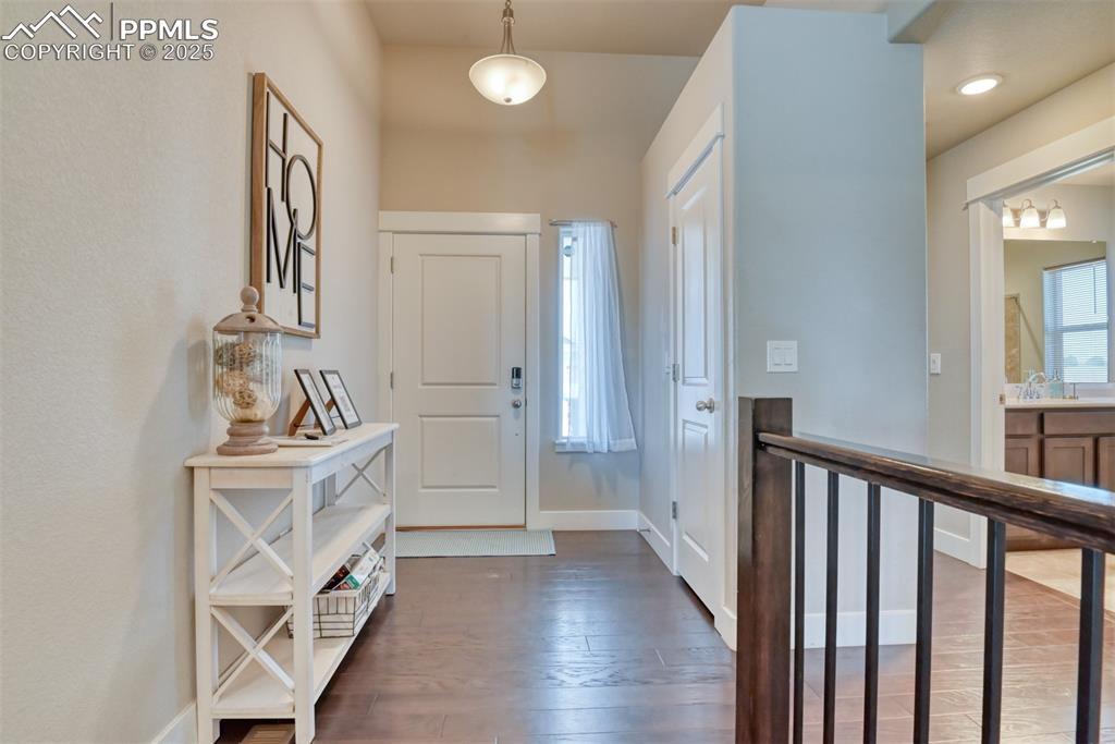 Image 6 of 45: Entryway with dark wood finished floors and healthy amount of natural light