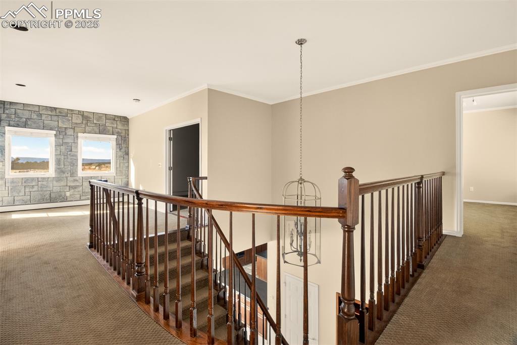 Image 26 of 50: loft area at top of stairs with windows looking out to view