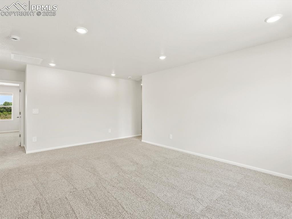 Image 21 of 44: Empty room featuring light carpet and recessed lighting
