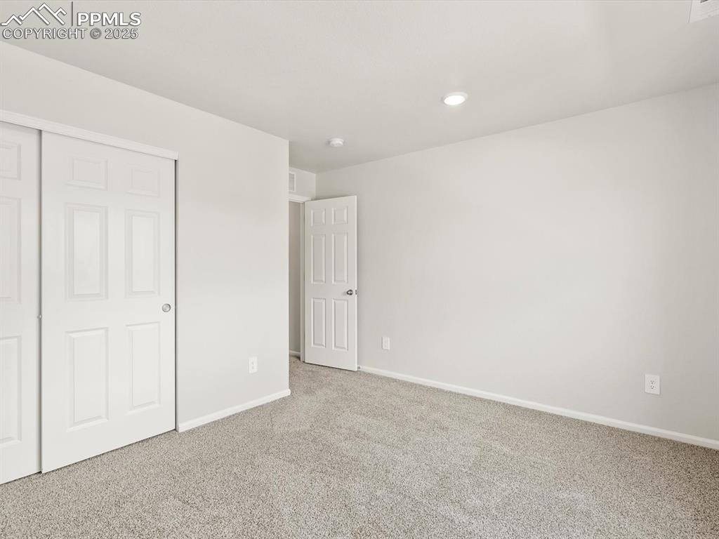 Image 23 of 44: Unfurnished bedroom featuring a closet, carpet flooring, and recessed light
