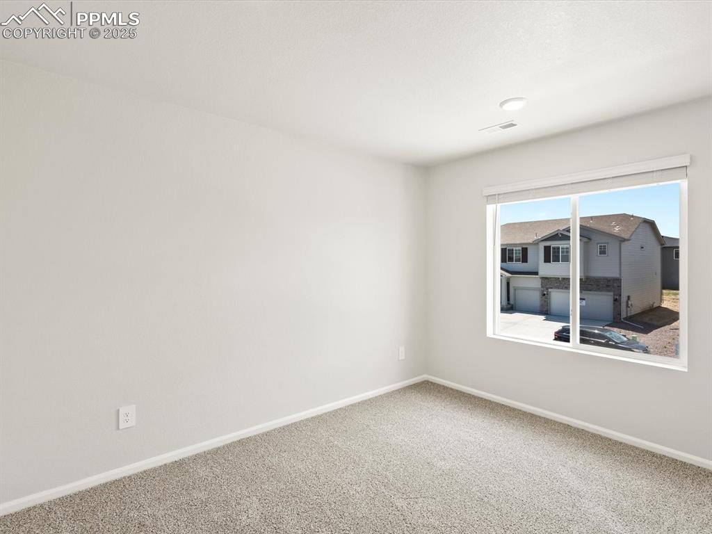 Image 26 of 44: Carpeted empty room with baseboards