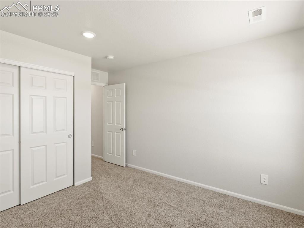 Image 29 of 44: Unfurnished bedroom featuring carpet flooring, a closet, and recessed light