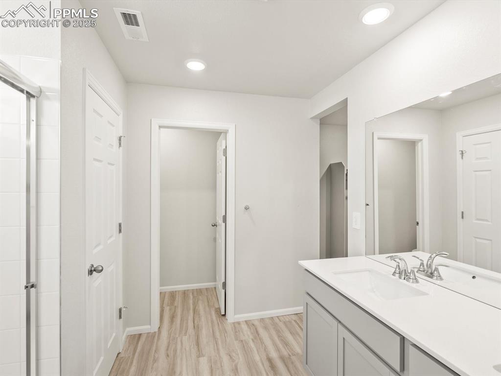 Image 33 of 44: Full bathroom with vanity, light wood-style flooring, recessed lighting, an