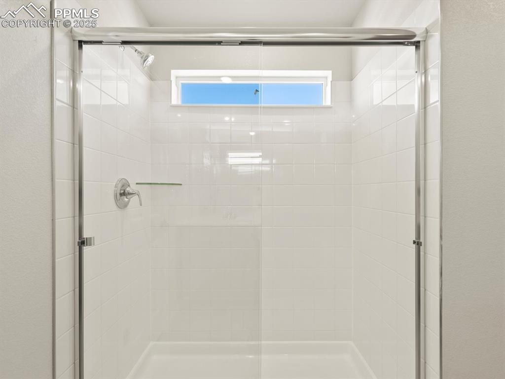 Image 35 of 44: Bathroom with a shower stall