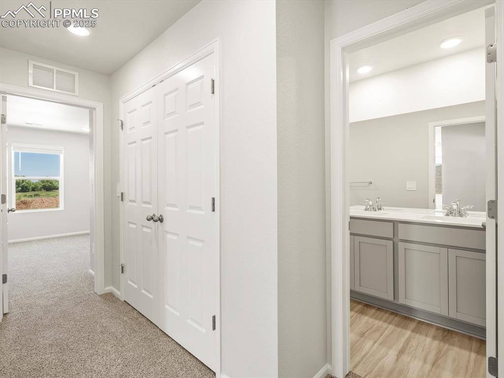 Image 37 of 44: Corridor featuring recessed lighting and light colored carpet
