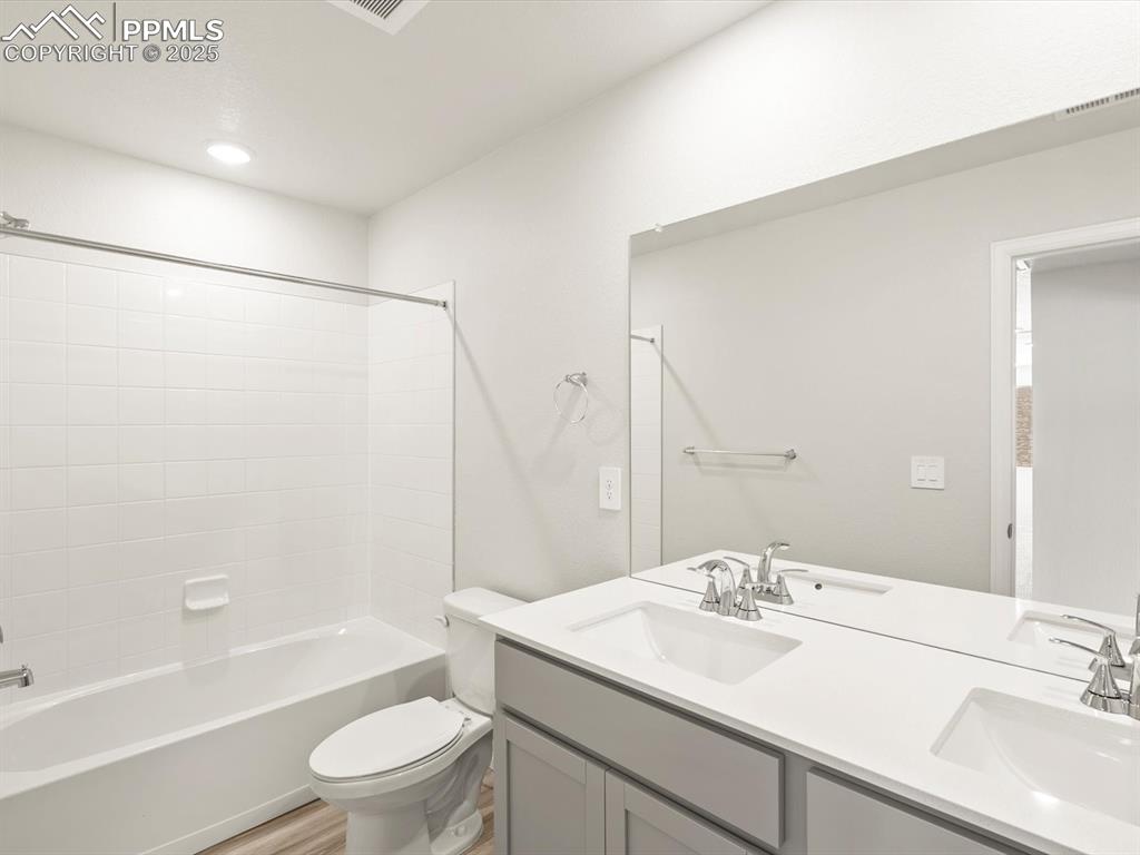 Image 38 of 44: Bathroom with shower / tub combination and double vanity