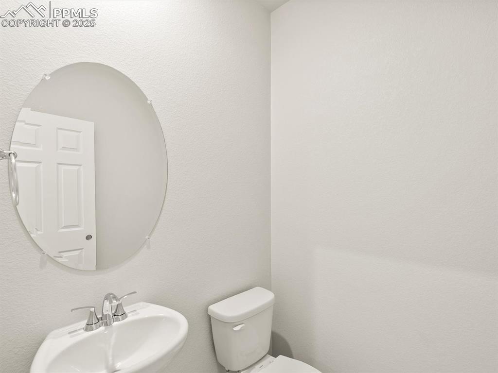 Image 39 of 44: Bathroom featuring a textured wall and a sink