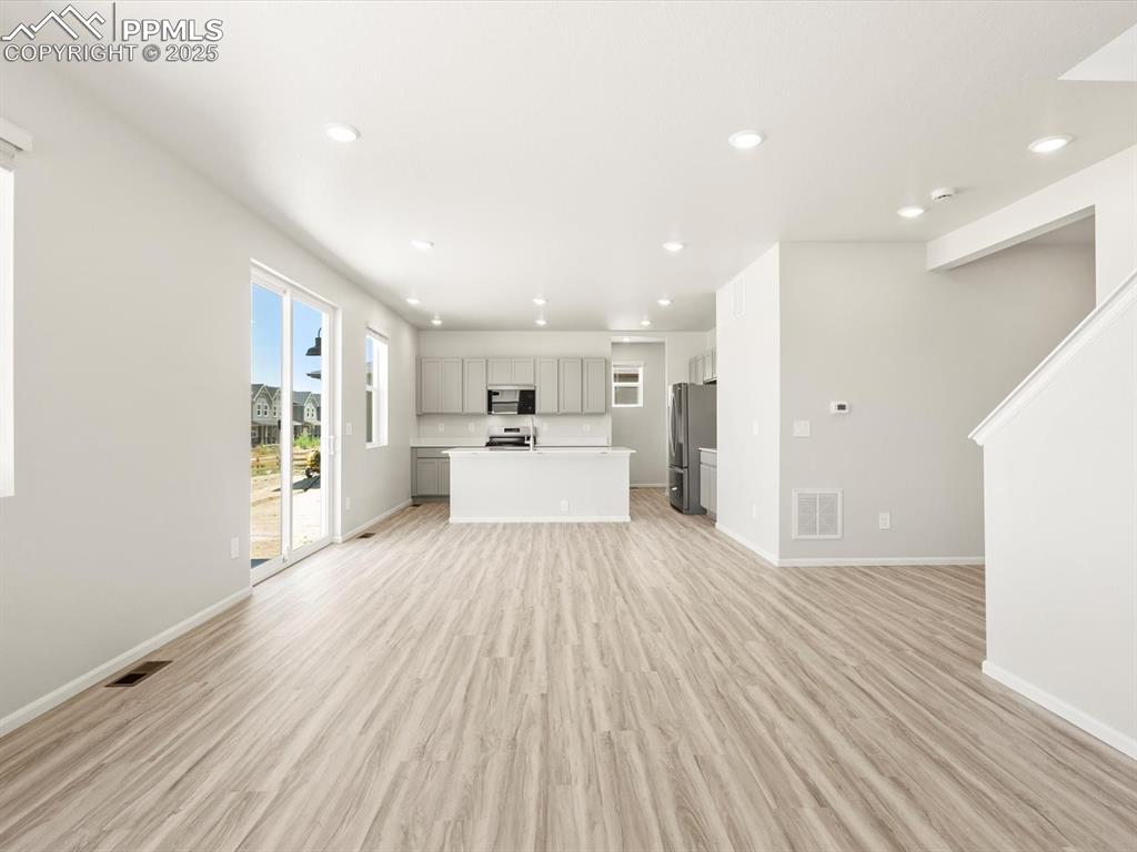 Image 4 of 44: Unfurnished living room featuring light wood-style flooring and recessed li