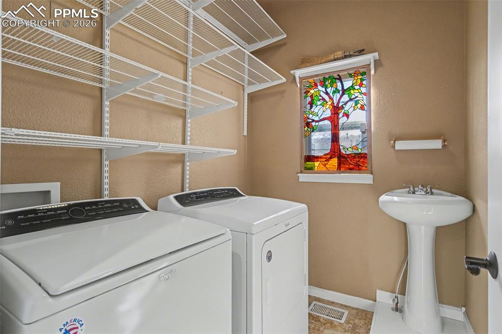 Image 19 of 48: Convenient Main Level Laundry Room with Sink!