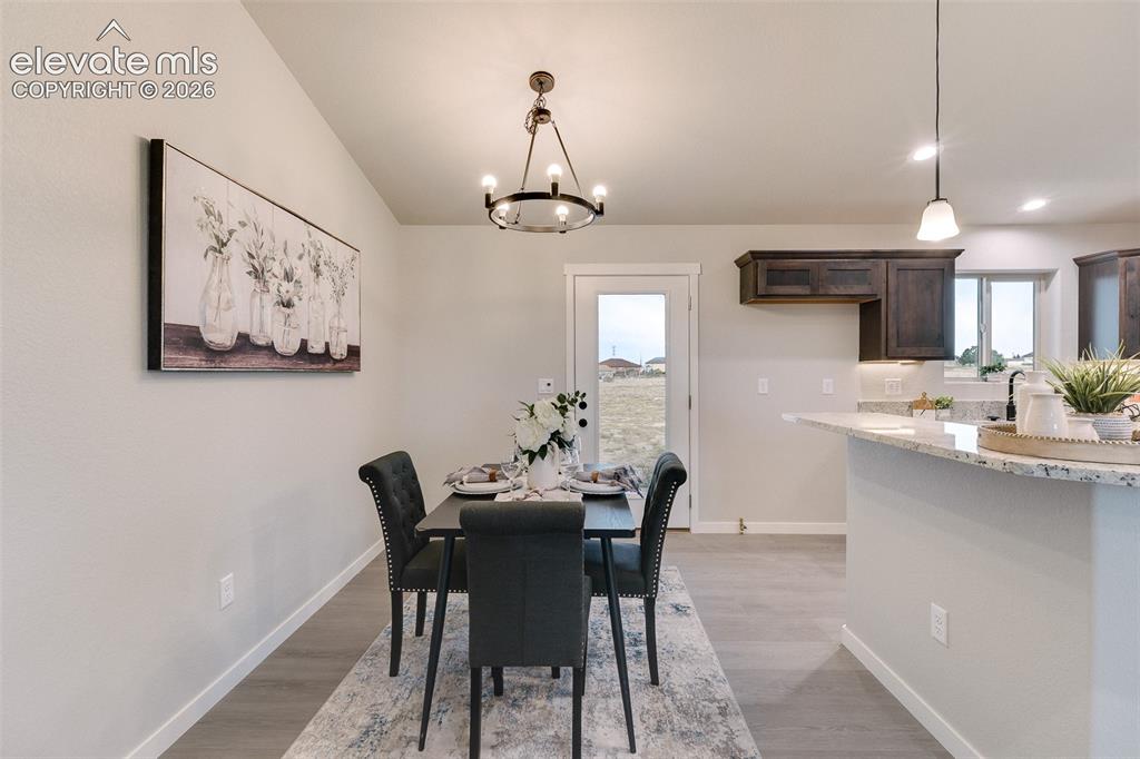 Image 11 of 28: Vaulted ceiling, wood-finish flooring, glass-paned exterior door, recessed 
