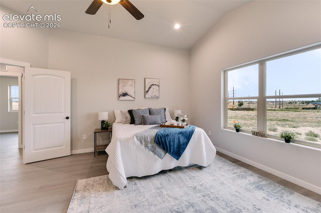 Image 14 of 28: Vaulted ceiling, wood-finish flooring, wide window with a deep sill, white 
