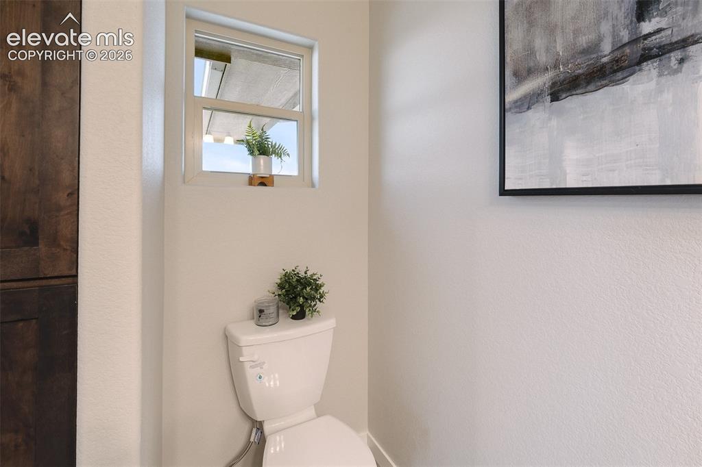 Image 19 of 28: White toilet with visible bidet attachment