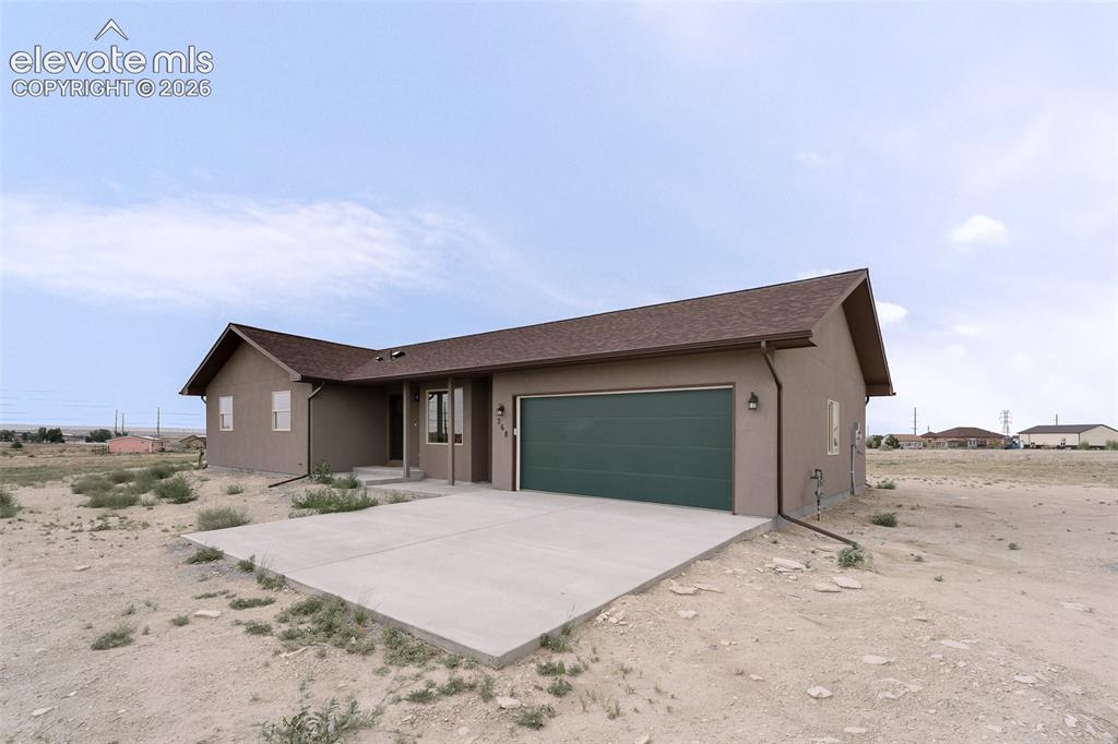 Image 2 of 28: Single-story residence featuring a brown shingle roof, stucco exterior, and