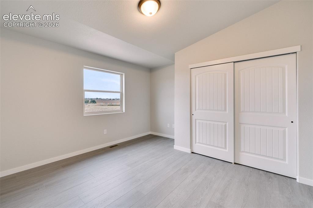 Image 20 of 28: Vaulted ceiling, recessed window, light wood-finish flooring, white sliding