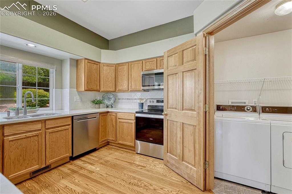 Image 15 of 48: A large stainless-steel French door refrigerator brings a touch of modern l